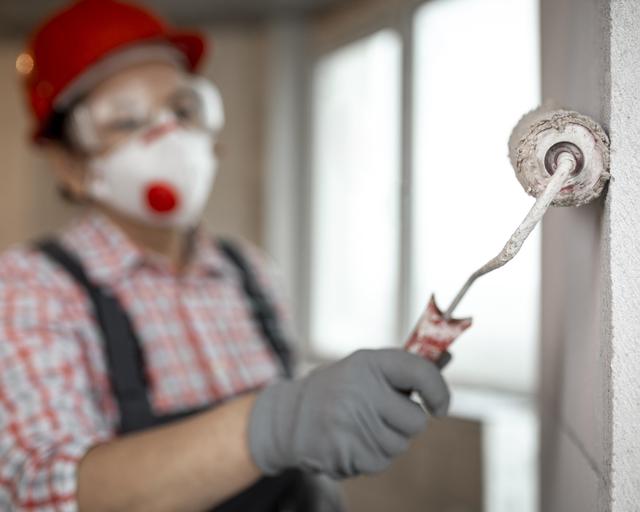 female-construction-worker-with-helmet-paint-roller